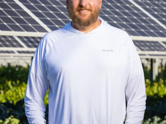 Greg Barron-Gafford in front of solar panels