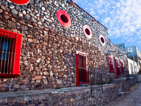 Cobbled street with red color house in Real de Catorce