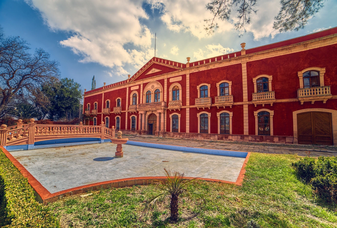 Facade of Gorgorron Hacienda with front garden and fountain