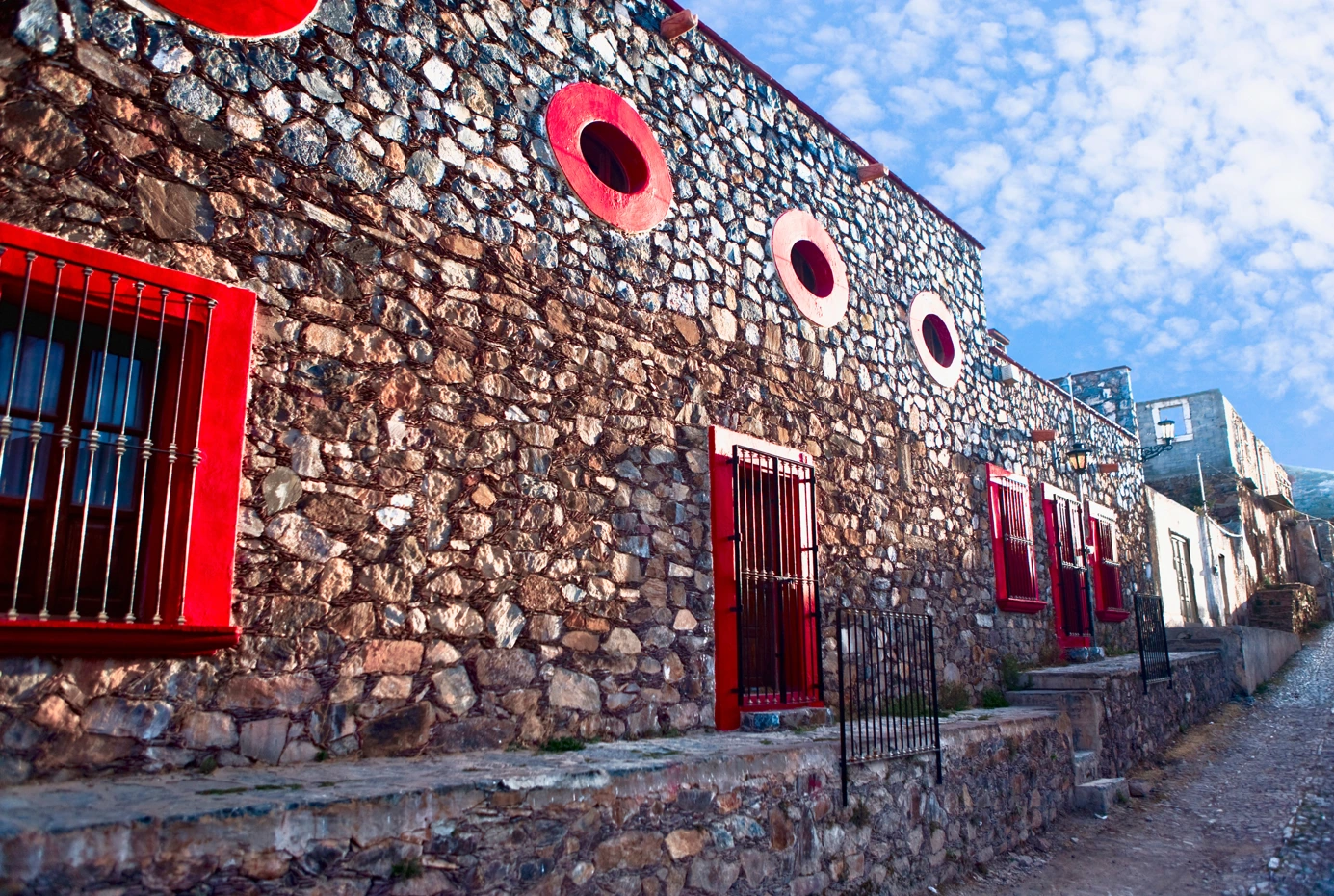 Cobbled street with red color house in Real de Catorce