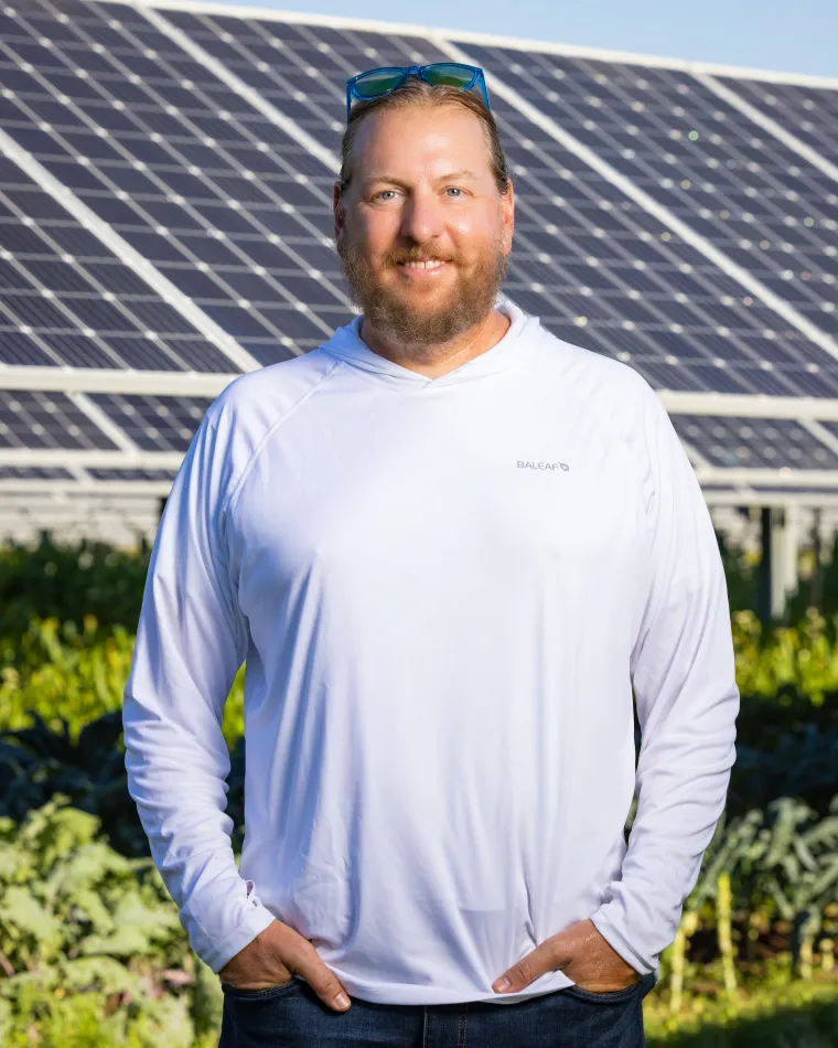 Greg Barron-Gafford in front of solar panels