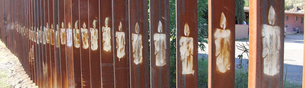 Candels drawn in pillars of US-Mexico border