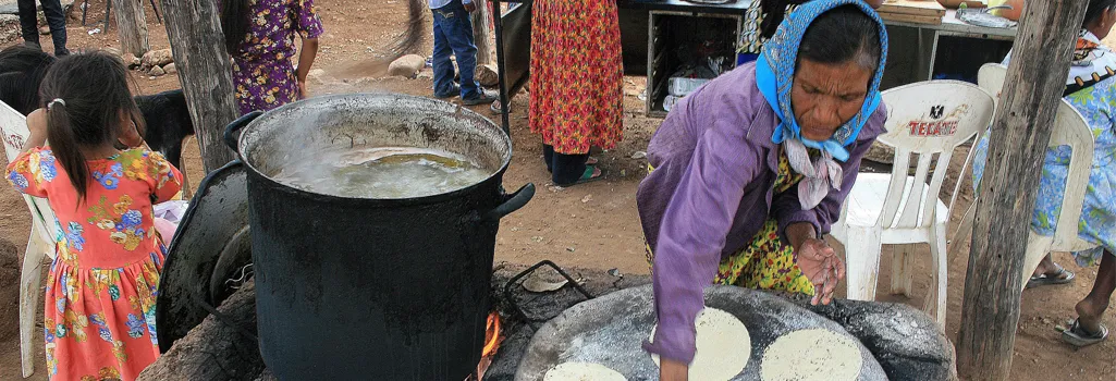 Woman making tortillas in outdoor kitchen