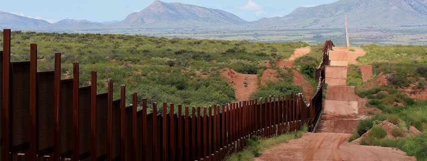 Metal border wall extending to horizon